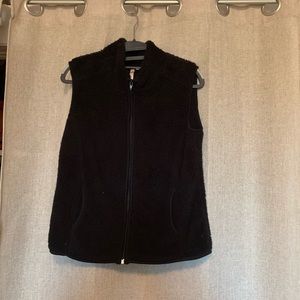 Black fuzzy vest.